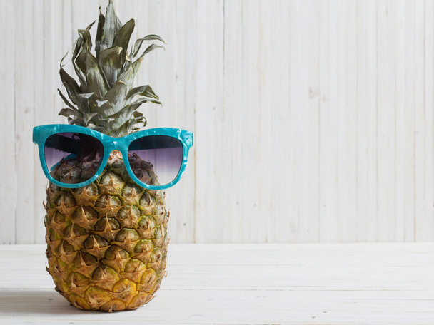 Ripe pineapple on a wooden background - 写真・画像
