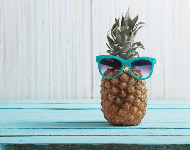 Ripe pineapple on a wooden background - Photo, Image