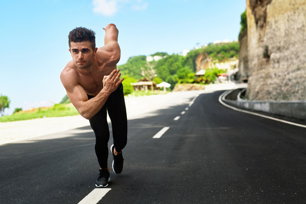 Athletic Man Ready To Start Running Outdoors. Sports Workout Concept - 写真・画像