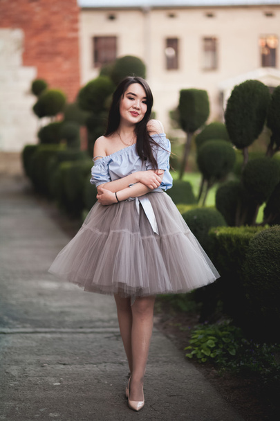 Young Asians girl with modern dress posing in an old Krakow - Фото, изображение
