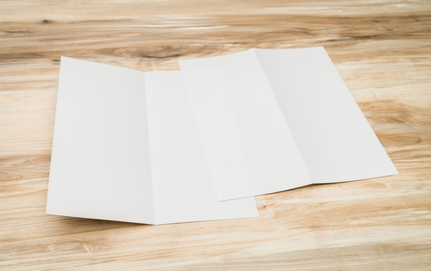 Bifold white template paper on wood texture - Foto, imagen