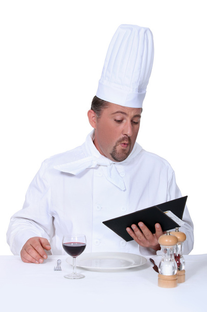 Chef choosing food from his own menu - Foto, imagen