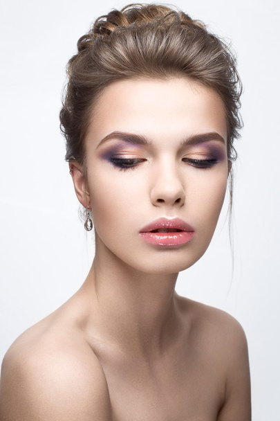Beautiful girl in an image of bride with a bundle of hair and gentle makeup. Beauty face - 写真・画像
