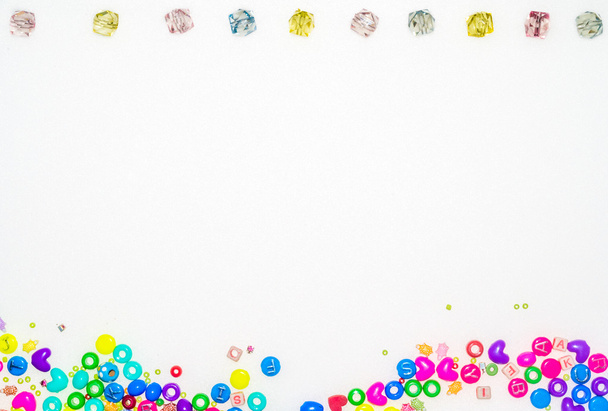 Background with fake jewels and colorful plastic gadgets - Фото, изображение