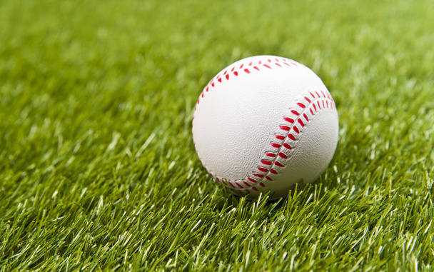Baseball on the fake green grass - Foto, imagen