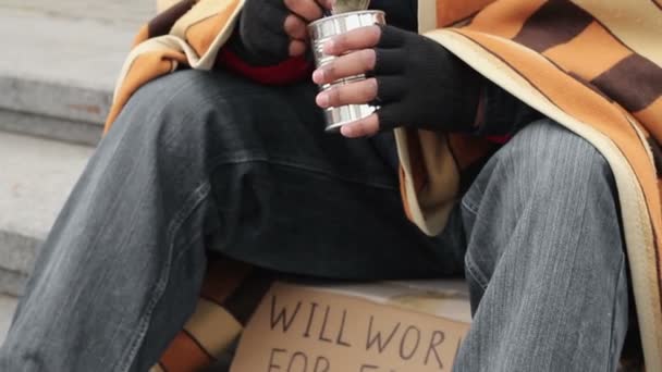 Starving homeless man eating canned food and asking for help, destitution - Filmagem, Vídeo