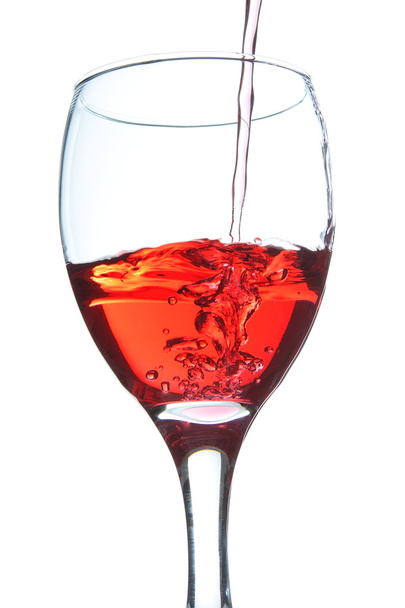 The wine pouring a drink into a glass. On a white background. - Foto, afbeelding
