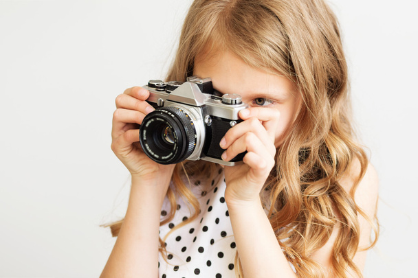 Portrait of a lovely little girl with old SLR film camera  - Foto, Imagen
