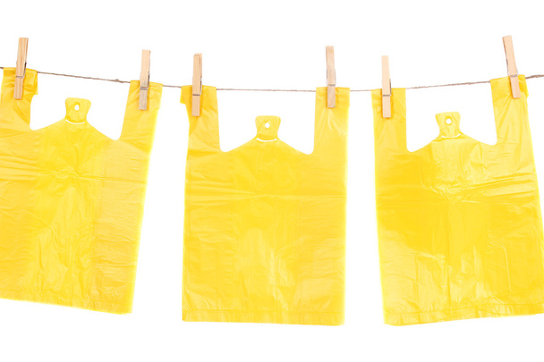 Cellophane bags hanging on rope isolated on white - Fotografie, Obrázek
