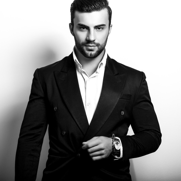 Elegant young handsome man in classic costume. Black-white studio fashion portrait. - Foto, Imagen