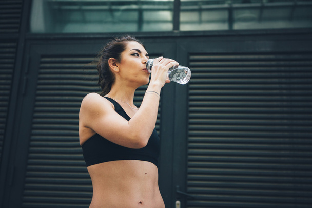 Sport woman. Rest.Drink water. Water bottle .Motivation. Sport concept - Fotografie, Obrázek