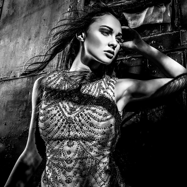 Dramatized image of sensual & attractive young woman in luxury dress posing outdoors. Black-white photo. - Photo, Image