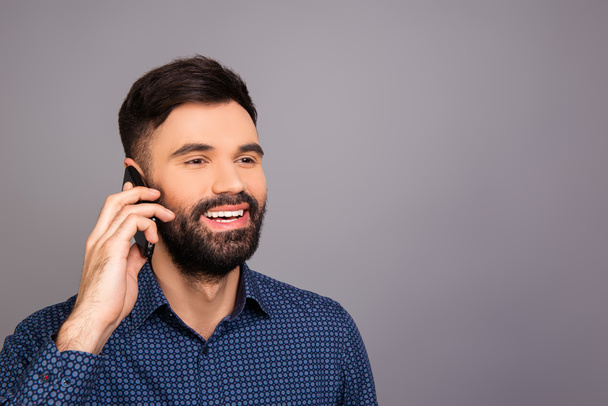 Handsome man talking on phone with his clients - Photo, image