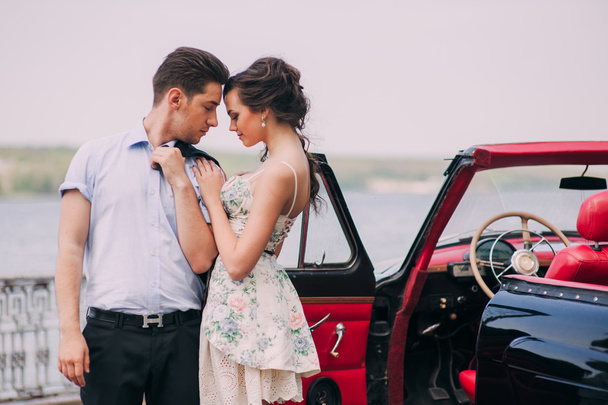Young couple with vintage car - 写真・画像