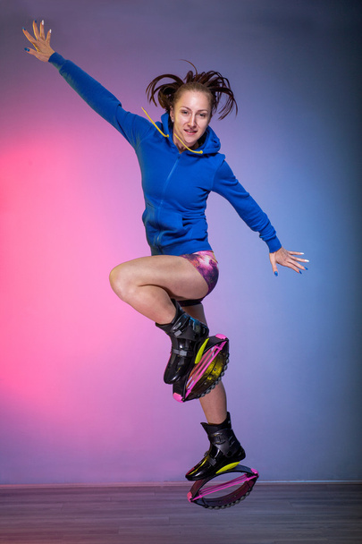 young girl exercising with kangoo shoes - Foto, afbeelding