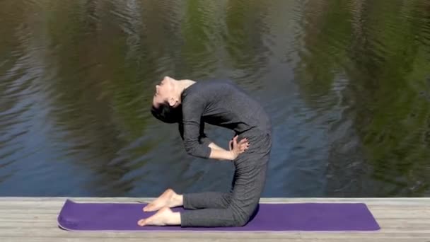 Yoga öğretmeni Camle poz suya yakın olun. - Video, Çekim