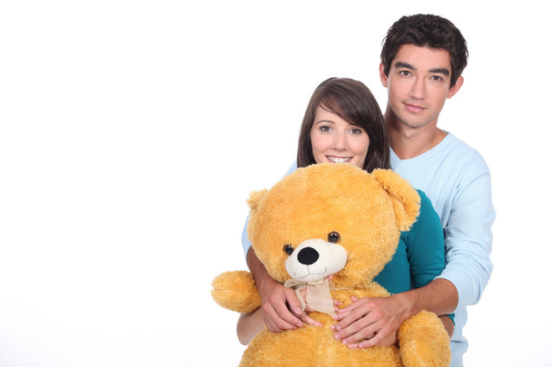 Teenage couple with a large stuffed bear - Fotó, kép