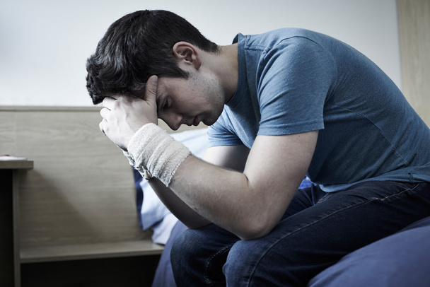 Depressed Young Man With Bandaged Wrists After Suicide Attempt - Fotó, kép