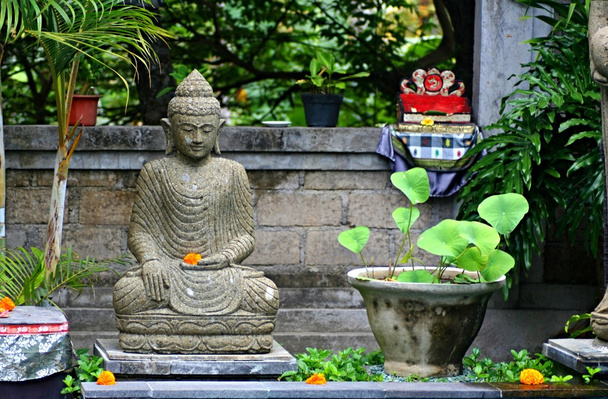 Typical Balinese sanctuary with statue of hindu god in the garden - Fotoğraf, Görsel