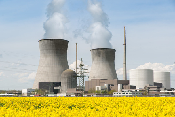 πυρηνικού σταθμού με κίτρινο πεδίο και το μεγάλο μπλε σύννεφα. - Φωτογραφία, εικόνα
