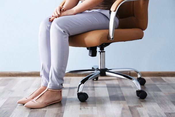 Woman sitting on the office chair - 写真・画像