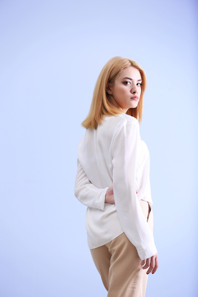 young woman in white shirt and beige pants  - Foto, Imagem