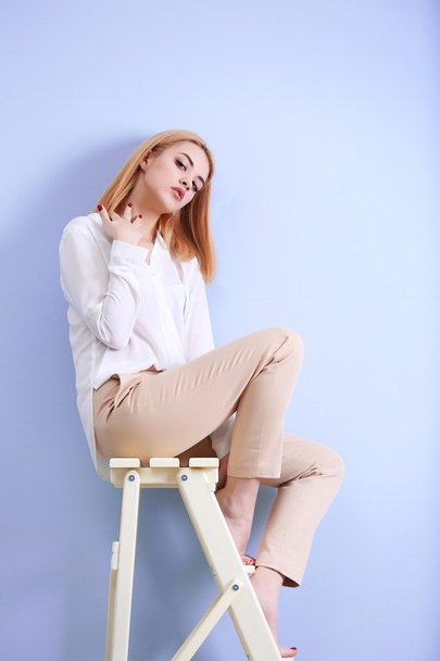 young woman in white shirt and beige pants  - Foto, immagini