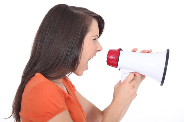 Woman screaming into a megaphone - 写真・画像