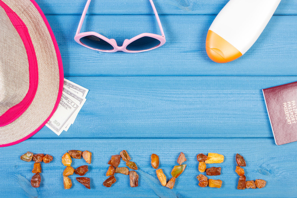 Word travel, sunglasses, straw hat, sun lotion, passport and currencies dollar, copy space for text - Photo, Image