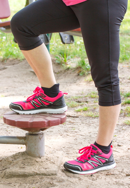 Legs of elderly senior woman on outdoor gym, healthy lifestyle - Valokuva, kuva