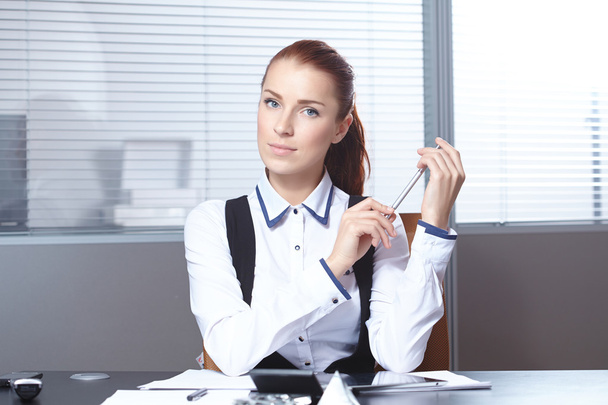 Young businesswoman at workplace - Foto, imagen