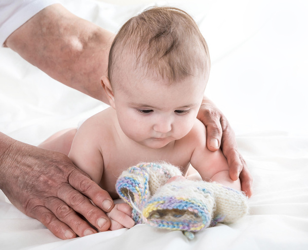  Grandmother knitted baby socks warm , caring for the child - Fotoğraf, Görsel