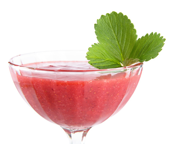 Close photo of strawberry dessert in goblet with leaf on white - Fotó, kép