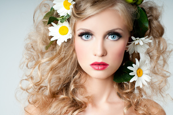 woman's face surrounded by flowers - 写真・画像
