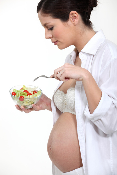 Pregnant woman eating salad - Photo, image