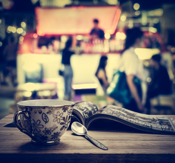 Tazza da caffè con caricatore su tavolo in legno
 - Foto, immagini