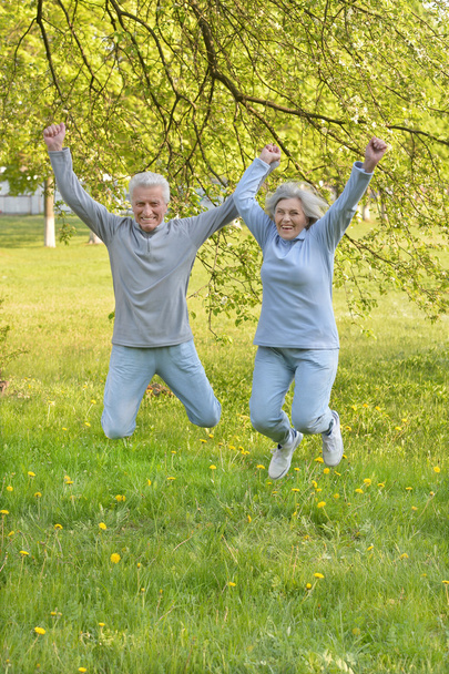 Happy fit senior couple jumping - Foto, Imagen