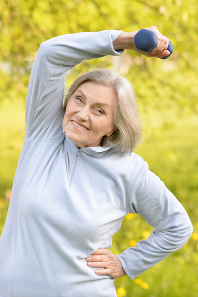 Mature woman with dumbbell - Photo, Image