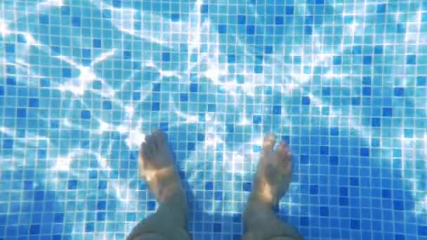 Männerfüße im sonnenbeschienenen Schwimmbad - Filmmaterial, Video