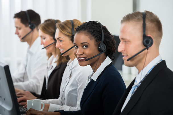 Businesswoman Working With Colleagues In Call Center - Foto, Bild