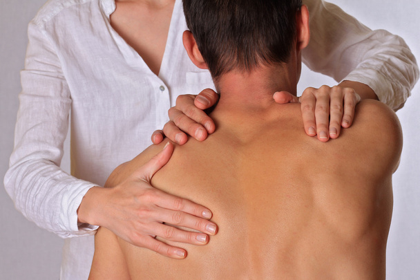 Chiropractic, osteopathy, physical therapy. Therapist  doing healing treatment on man's back. Alternative medicine, pain relief concept - Foto, immagini