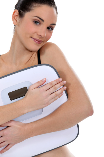 Woman holding bathroom scales - Photo, Image