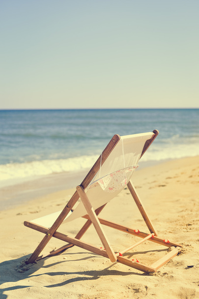 Deckchair and female hat on stunning tropical beach vacation background - Photo, image