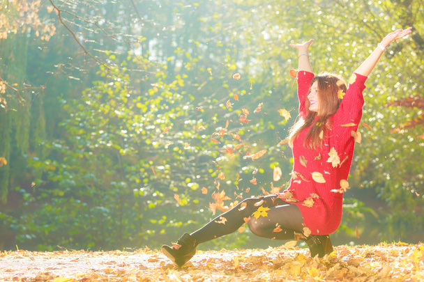 Crouching girl in autumnal forest.  - Photo, Image