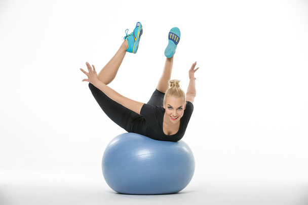 Sportive blonde lies on fitball - Photo, image