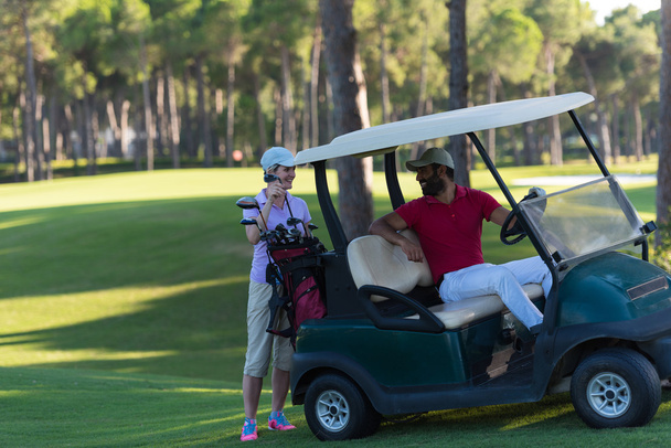 couple in buggy on golf course - 写真・画像