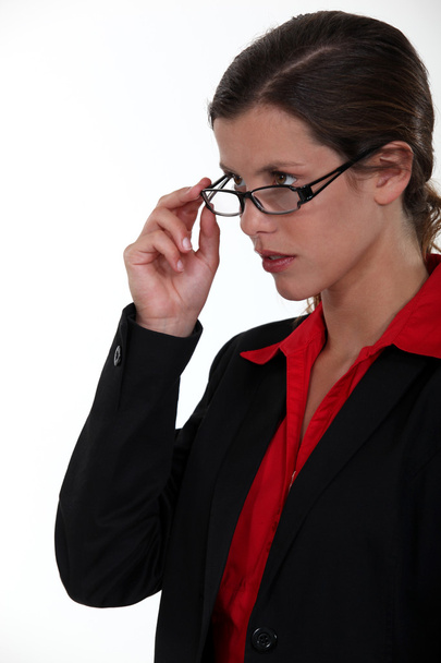Serious businesswoman lifting glasses - Foto, afbeelding
