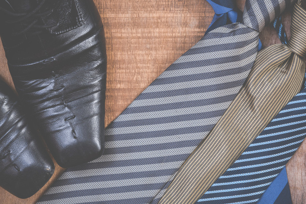 Necktie and shoes on grunge wood background - Photo, Image