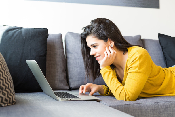Woman relaxing with a laptop  - Photo, Image