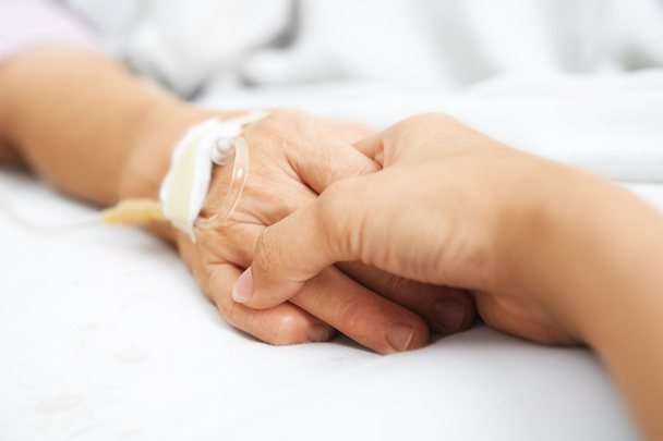 Daughter holding her mother hand in hospital - Valokuva, kuva